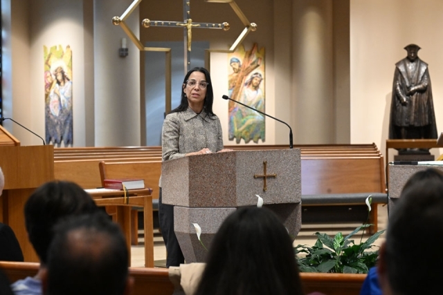 Dean Delgado speaking at ambo