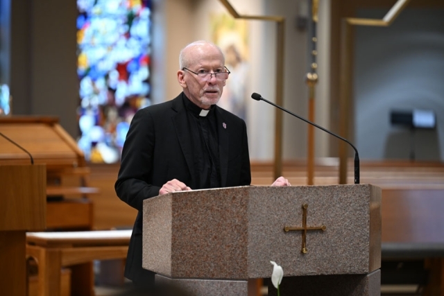 Fr. Shanley speaking at ambo