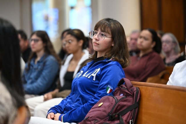 Female student sitting in church pew