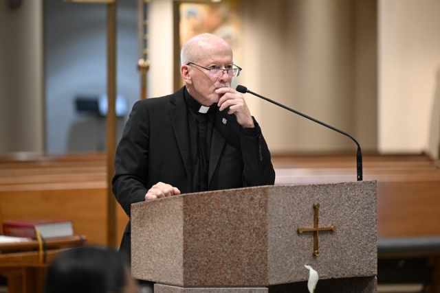 Fr. Shanley speaking at ambo