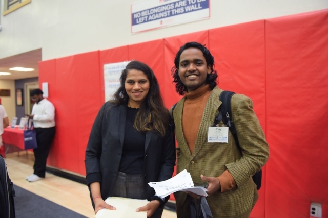 Male and female student smiling