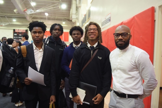 group of males and females smiling for photographer