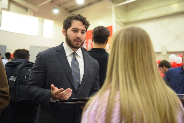inset of male speaking with female