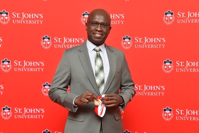 Male honoree holding award