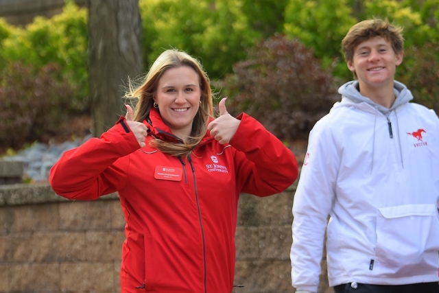 Student ambassadors giving thumbs up