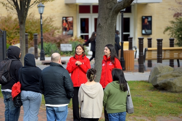 Prospective students and parents touring outside on campus