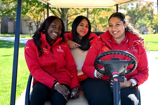 Student ambassadors driving golf cart