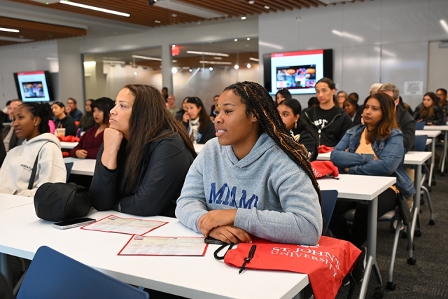 Prospective students and family members in classroom