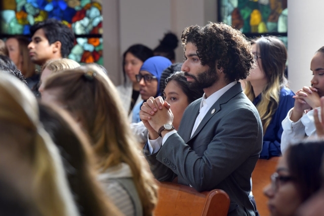 Inset of people kneeling in pews