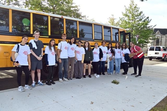 Service Day participants lined up outside of school bus