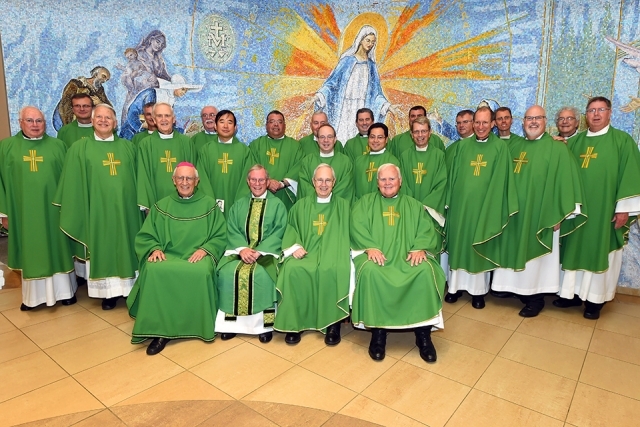 Rev. Stephen Bicsko, C.M. and priests wearing green 