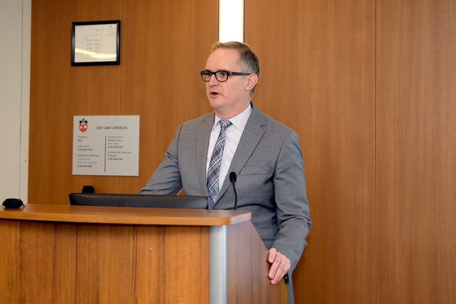 Male speaker at podium during a lecture hall