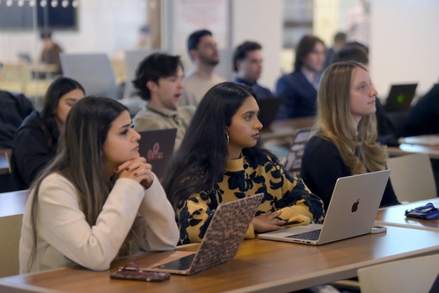 students listening at their desks in a lecture hall