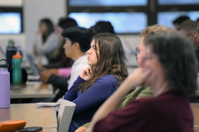 students listening at their desks in a lecture hall