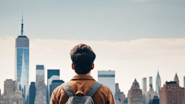 back view of male student looking at NYC skyline
