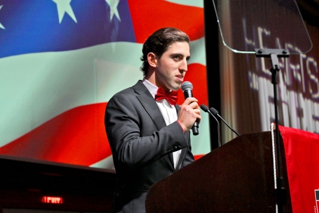 Man speaking or singing at podium