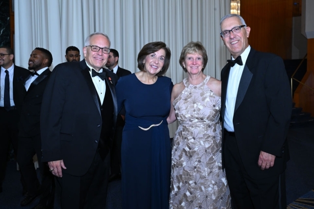 Attendees mingling and smiling