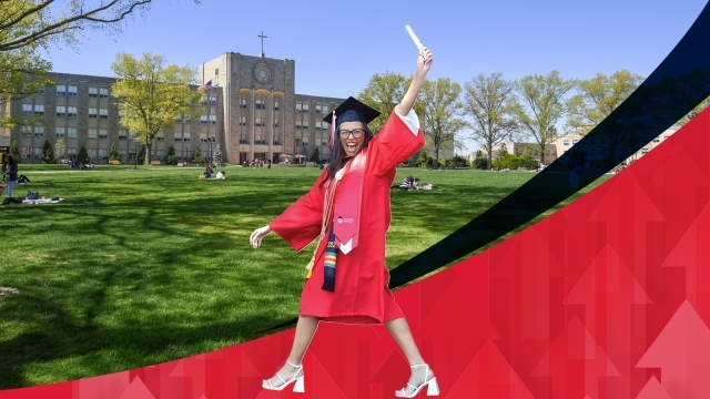 Female graduate walking with diploma raised