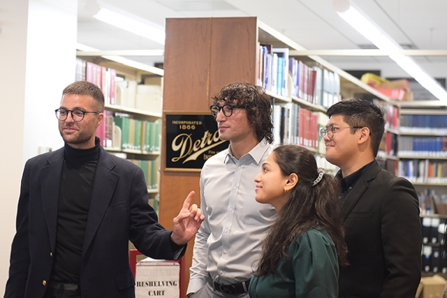 Students and alumnus in library