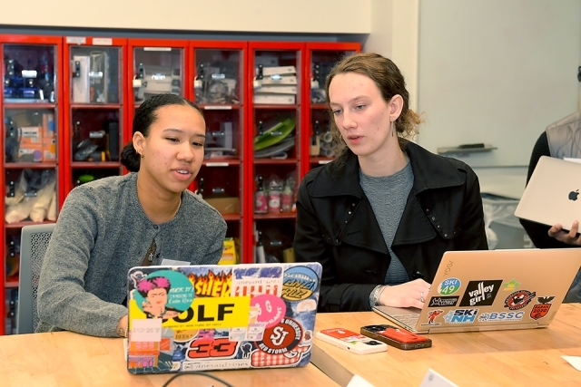 Two students working on their laptops