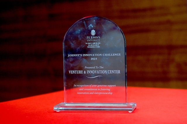 Johnny's Innovation Challenge glass plaque on red table