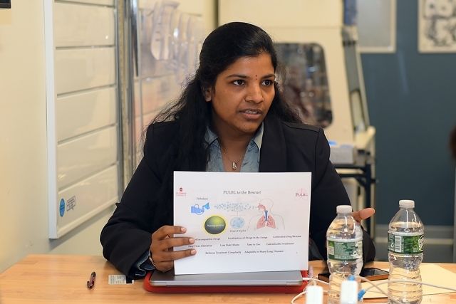 Woman at Johnny's Innovation Challenge holding up paper