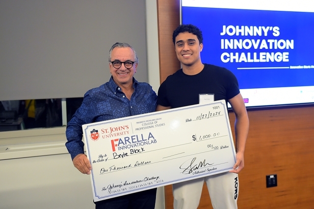 Johnny's Innovation Challenge winner and man holding giant check