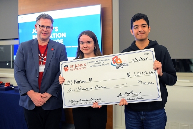 Students holding a large check for winning a innovation challenge