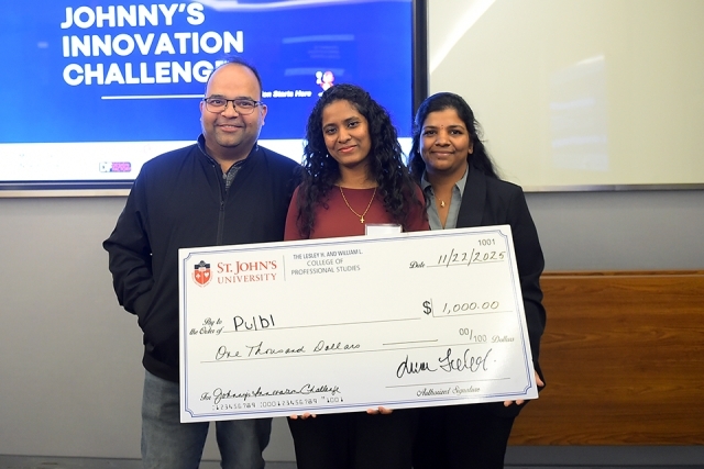 Johnny's Innovation Challenge winners and man holding giany check