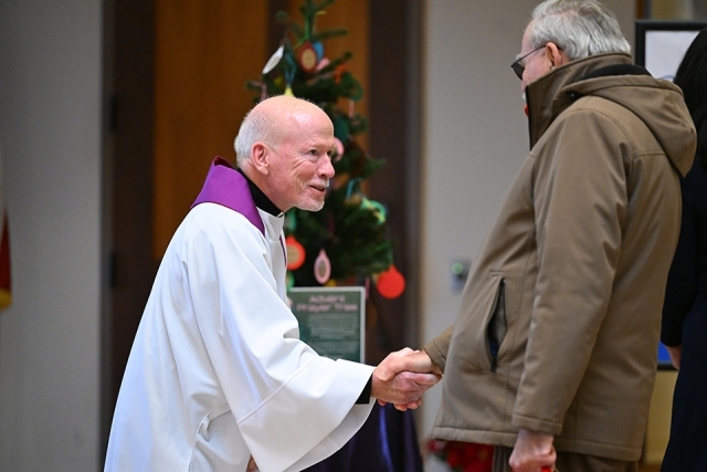 Fr. Shanley shaking a man's hand