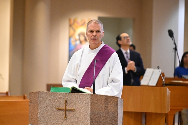 Joe Oliva speaking at ambo