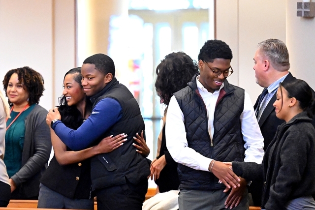 Mass attendees exchanging signs of peace