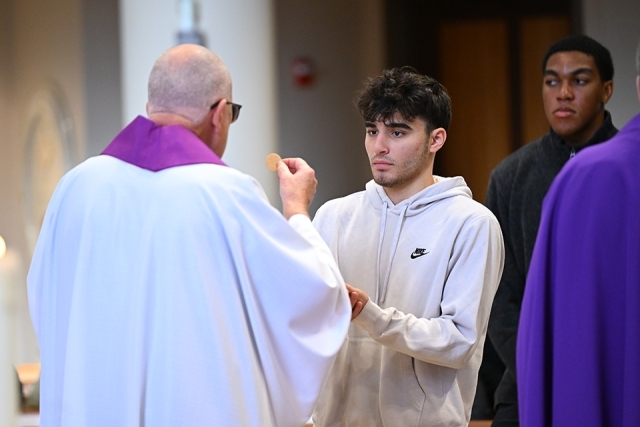 Male student receiving communion