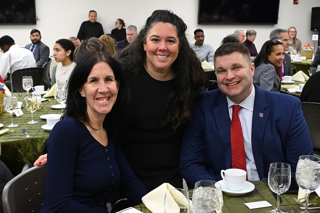Three people smiling for a photo
