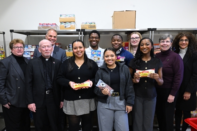 Group of people standing smiling in food pantry