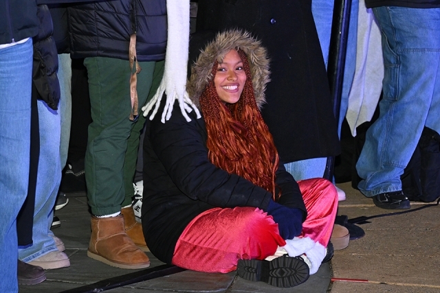 Student smiling while sitting on the ground