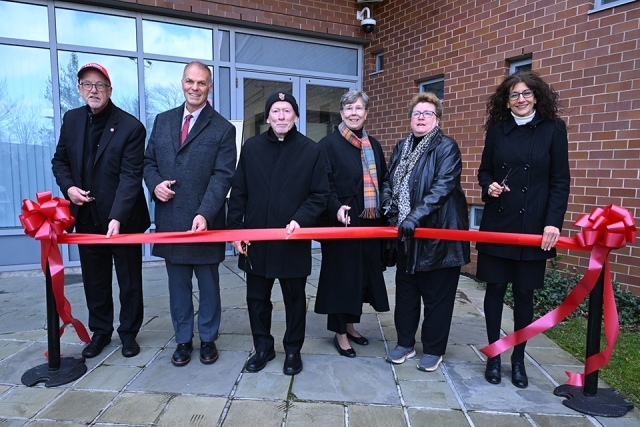 University employees cutting red ribbon