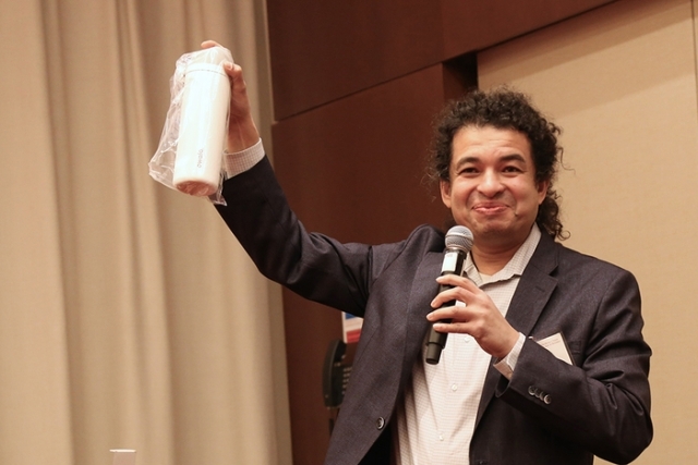 Man holding paper towel in suit 
