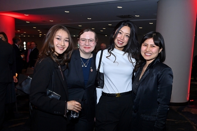 Four attendees posing together at a reception area during the Insurance Leader of the Year Award Dinner.