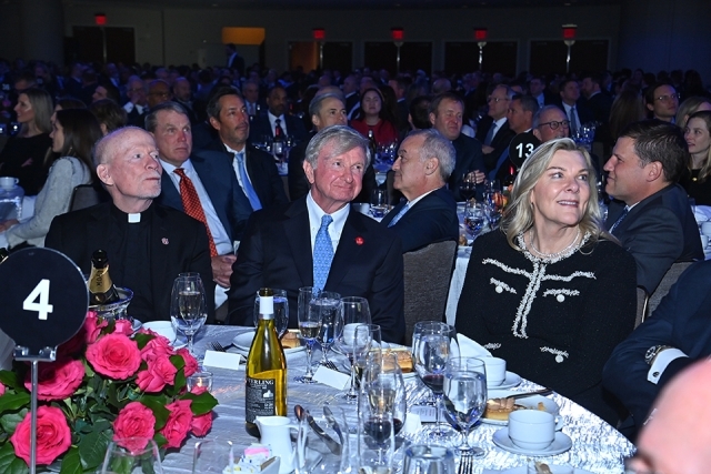 Audience members seated at a table and looking toward the stage during the Insurance Leader of the Year Award Dinner.