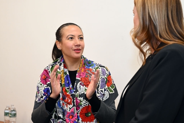 women speaking to another woman 