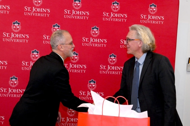 man shaking another man's hand 