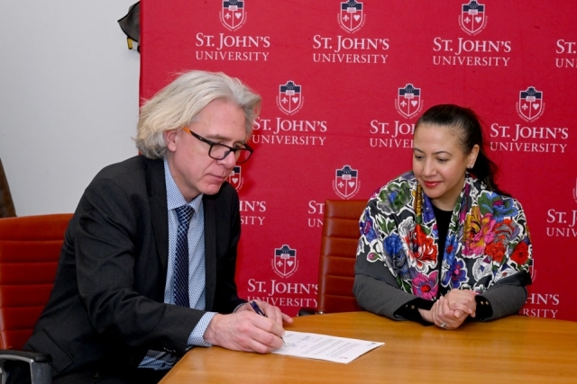 man signing a bill at the table 