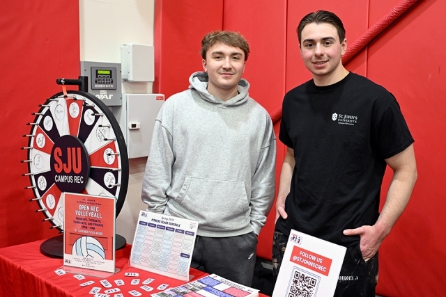 2 students at a presentation table 