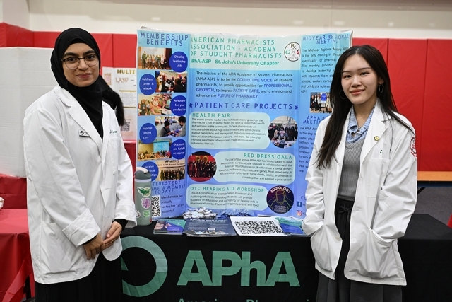 2 students at a presentation table 