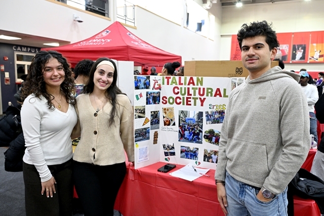 3 students at a presentation table 