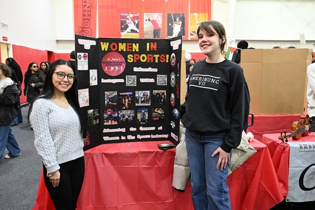 2 students alongside a presentation board 