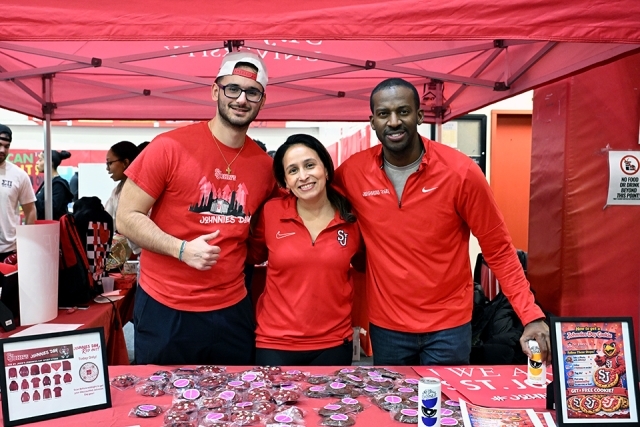 a group of three people wearing red shirts 