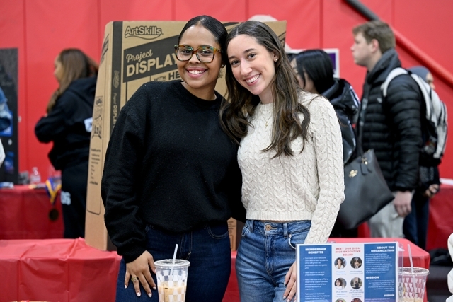 2 woman standing next to each other 