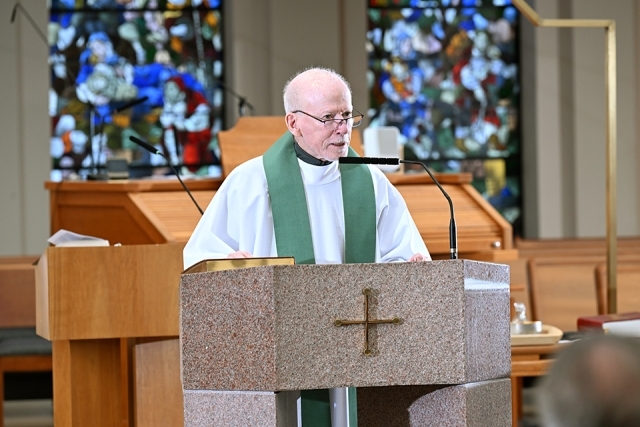 Priest standing at a podium 